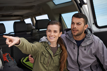 Image showing Couple, car and pointing on roadtrip with travel for adventure, vacation or sightseeing with happiness in countryside. Woman, man or driving in vehicle for holiday journey, tourism and honeymoon trip