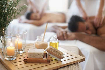 Image showing Candle, brush and couple in spa to relax on bed with luxury pamper treatment tools on table in hotel. Beauty, facial oils or woman with man at resort or salon for natural healing benefits or massage