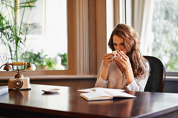 Image showing Woman, drink and writer with coffee in office to relax before writing on desk, paper or notebook with ideas. Person, thinking and enjoy tea with remote work in home as journalist planning article