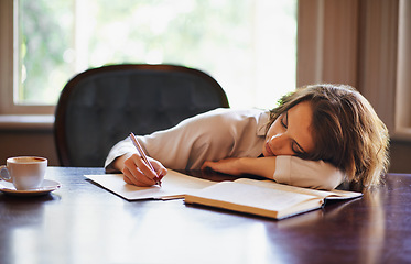 Image showing Remote work, sleeping and tired woman with books, fatigue or snooze while writing in home office. Freelance, burnout or female writer with pen in a house exhausted by reading, research or novel notes