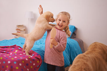 Image showing Girl, child and puppy with portrait on bed for playing, bonding and protection in bedroom of home with brush. Kid, golden retriever and dog for companion, affection and embrace with care in apartment