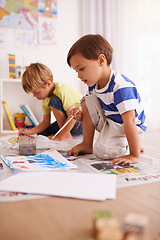 Image showing Boys, paper and painting on floor for creative development, fun activity and education in playroom. Children, bonding and drawing at home for learning, artistic hobby and homework together in house