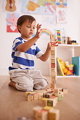 Image showing Home, child or balance with building blocks for playing and learning for development or growth in playroom. Relax, education and playful with activity, young toddler kid and fun games for creativity