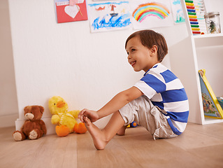 Image showing Floor, boy or child with smile for playing and learning with development and growth at home in playroom. Happiness, activity and playful with teddy bear, young toddler kid and fun games for