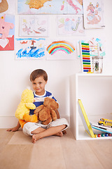 Image showing Child, toy and portrait with teddy, smile and happiness for fun and joy at home or daycare. Boy, play and positive with stuffed animal, laugh and childcare for growth and cheerful on wood floor