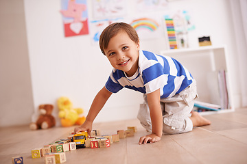 Image showing Home, portrait or kid with building blocks for playing and learning for development or growth in playroom. Relax, playful or happiness with activity, young child toddler and fun games for creativity