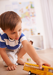 Image showing Bus, house or child with toy for playing and learning with development and growth at home in playroom. Happiness, activity and boy with yellow truck, young toddler kid and fun games for entertainment