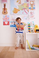 Image showing Child, boy and truck in playroom for toy, learning and development with color, picture and book for fun at home. Young kid and smiling for recreation, childhood and growing for innocent and adorable