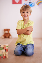 Image showing Smile, portrait or kid with building blocks for playing and learning for development or growth in playroom. Relax, playful or happiness with activity, young child toddler and fun games for creativity