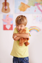 Image showing Happy, portrait and child hug teddy bear in kindergarten, class and comfort from stuffed animal. Kid, embrace and cuddle toys for support in school, classroom and playing with kindness and love