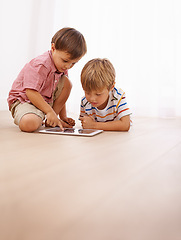 Image showing Children, tablet and siblings on a floor with cartoon, gaming or streaming movie at home. Digital, learning and boy kids in house for google it, search or ebook storytelling, app or Netflix and chill