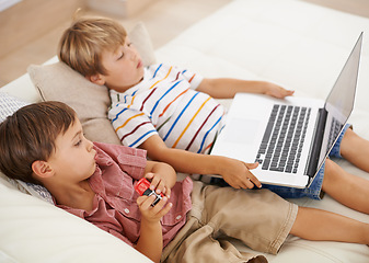 Image showing Laptop, relax and kids on sofa in home, learning and family streaming cartoon on internet together. Computer, children and boys in living room for education, movies or brothers with games in house