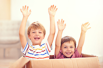 Image showing Children, box or portrait of siblings playing in house for fun, bonding or hands up game. Cardboard, learning and excited kids in living room for celebration, imagine or rollercoaster fantasy at home