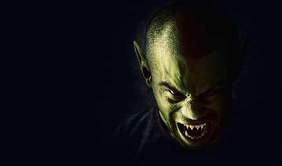 Image showing Monster, man and devil face in studio for fantasy, horror and angry vampire with fangs, scary and terror. Werewolf, demon and creepy creature with mockup, rage and surreal alien on black background