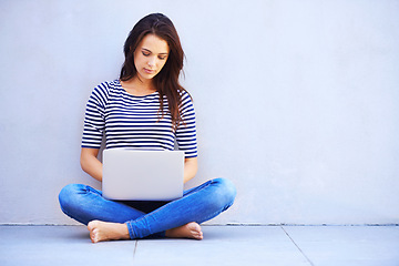 Image showing Typing, woman and relax on floor with laptop for remote work or freelancing, web browsing and research for idea or project. Female person, casual and computer for internet, social media and blog.