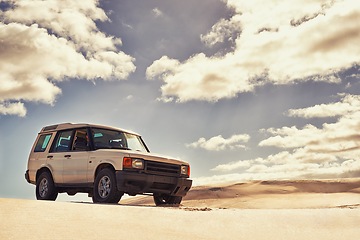 Image showing Jeep, sand or driver in nature for travel, adventure or driving in rugged terrain or dry environment. Car, transportation or man in off road exploration on trail, journey or outdoor dunes in desert