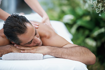 Image showing Luxury, spa and man relax for massage on table in hotel, calm and care for body in vacation. Holiday, outdoor and male person on break for weekend, accommodation and lodge with treatment for skincare