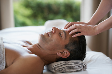 Image showing Relax, head massage and man at salon for skincare, peace and calm at luxury resort at table for wellness. Beauty, therapy and masseuse at spa for face treatment, health and hands of person pampering