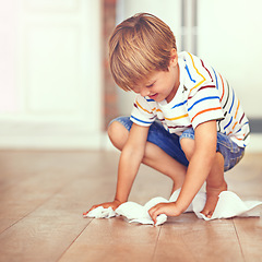 Image showing Boy, floor and cleaning in home for mess, spill or household chores for childhood development. Little boy, toilet paper and maintenance in house with hygiene, housework and learning responsibility