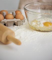 Image showing Baking, kitchen and eggs in bowl with flour for cake, bread and pastry preparation in home. Culinary, bakery and closeup of ingredients, wheat and utensils for pizza, dough and food on counter