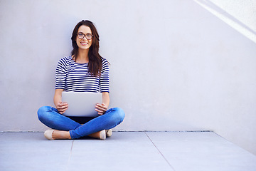 Image showing Portrait, woman and relax on floor with computer for remote work or freelancing, web browsing and research for idea or project. Female person, casual and laptop for internet, social media and blog.