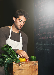 Image showing Chef, basket and business owner with vegetables or groceries in a bag for cooking or diet in kitchen. Man packing, shopkeeper and person sorting healthy food dinner or packaging box of ingredients