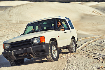 Image showing Car, desert and people driving for travel and transportation outdoor, off road vehicle for sand dunes and journey on vacation. Van, 4x4 or SUV with adventure, explore destination and tourism in Dubai