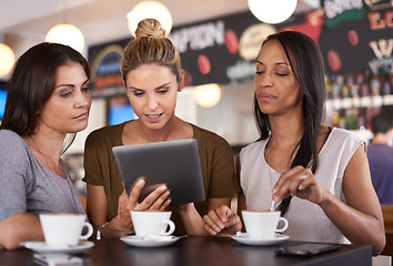 Image showing Woman, together and read at coffee shop with tablet for online menu or restaurant review, diversity and relax for leisure. Female friends, digital technology and internet to search or browse website.