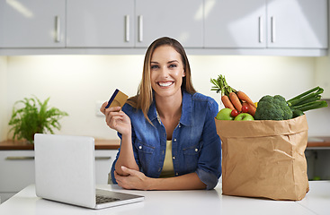 Image showing Happy woman, laptop and credit card with grocery bag for payment, online shopping or order in kitchen at home. Portrait of female person with smile, computer or debit in purchase or delivery at house