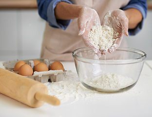 Image showing Hands, person and flour with eggs, kitchen and rolling pin for baking. Baker, dough and food with countertop, apron and mixing for recipe preparation and recreation or hobby at home or house