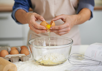 Image showing Hands, person and eggs with flour, baking and kitchen for whisk with utensils. Baker, pastry and food with countertop, apron and cookbook for recipe preparation and recreation or hobby at house