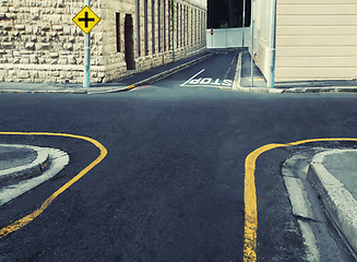 Image showing Crossroads, intersection at road for travel direction in city or decision choice for pathway journey, symbol sign or navigation. Street, four way and outdoor location or London, adventure or building