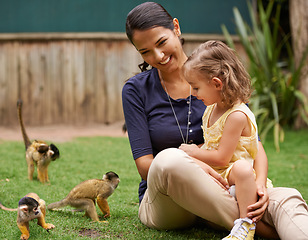 Image showing Animal, mother and young girl with monkey for wildlife rescue, outdoor activity or interactive experience in nature. Conservation, zoo and happy family for bonding, holiday and travel at sanctuary