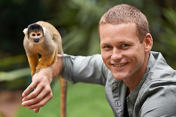 Image showing Man, portrait and monkey at nature zoo as sanctuary veterinary for rehabilitation trust, support or protection. Male person, face and animal in sustainable environment in Indonesia, holiday or travel