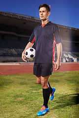 Image showing Man, exercise and confident soccer player in stadium, athlete and competitive for match or game. Male person, serious face and determined for competition, outdoors and focus for football challenge