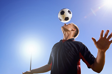 Image showing Football, bounce and head with man, game and training with competition, sunshine and exercise. Blue sky, lens flare and player with practice or athlete with skills or technique with fitness or soccer