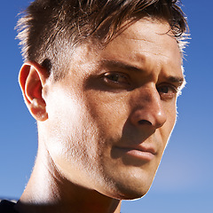 Image showing Man, portrait and confident soccer player in outdoors, athlete and competitive for match or game. Male person, serious face and determined for competition, blue sky and focus for football challenge