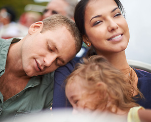 Image showing Circus, fun and family in rollercoaster for holiday in USA for cute toddler and happiness in outdoor trip. Amusement park, father and daughter sleeping on mom with smile, love and care in ride