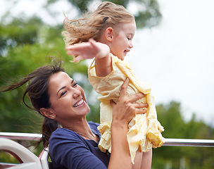 Image showing Ride, mother and child with happiness in amusement park for freedom in rollercoaster in summer. Nature, woman and girl together for fun, joy and outdoor in circus for growth and development of kid