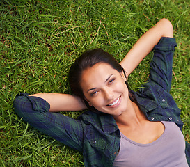 Image showing Relax, nature and portrait of woman on grass for peace, satisfaction and good mood in outdoor park. Summer, green lawn and face of woman with happiness for rest, wellness and carefree enjoyment