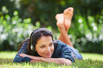 Image showing Grass, thinking and woman with headphones, relax and streaming music with peace, sound and sunshine. Person in a park, outdoor and girl with headset and podcast with radio and weekend break in garden