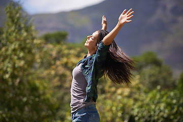 Image showing Freedom, wellness and hands raised with young woman relax in garden for enthusiasm or inspiration. Nature, park and smile with happy person outdoor at park in summer for energy or excitement