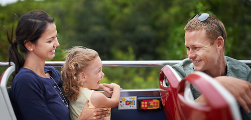 Image showing Amusement park, smile and happiness for family with toddler, mother and father together with kid. Holiday, woman and man with girl in transport for fun, laughter and joy with child in America