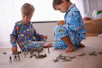 Image showing Boys, playing and kids in pajamas with toys for fun with action figures, car or games. Brothers, child development and young children bonding together in playroom for learning at family home.