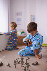 Image showing Boys, toys and young children in pajamas playing for fun with action figures, car or games. Brothers, child development and young kids bonding together in playroom for learning at family home.