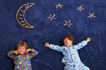Image showing Smile, playing and children with funny face for night, moon and stars carpet. Happiness, above view and siblings for playful facial expression, growth and childhood development in bedroom floor
