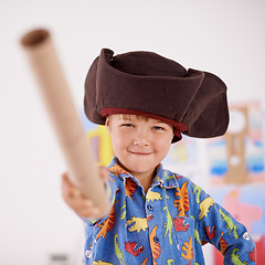 Image showing Child, portrait or costume as pirate to play in fantasy in his bedroom with telescope toy or smile. Kid sailor, proud captain or happy boy in a game with pyjamas, hat or creative monocule to sail