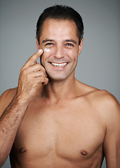 Image showing Mature man, portrait and lotion in studio, beauty and collagen cosmetics for anti aging. Male person, facial treatment and dermatology on gray background, cream and apply moisturizer for hydration