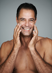 Image showing Mature man, portrait and moisturizer in studio, beauty and collagen cosmetics for anti aging. Happy male person, treatment and dermatology on gray background, cream and apply lotion for hydration