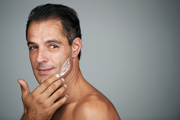 Image showing Man, smile and studio with face cream, mature male person with skincare and moisturizing lotion. Dermatology, anti aging product with mockup for facial treatment, natural grooming for wellness